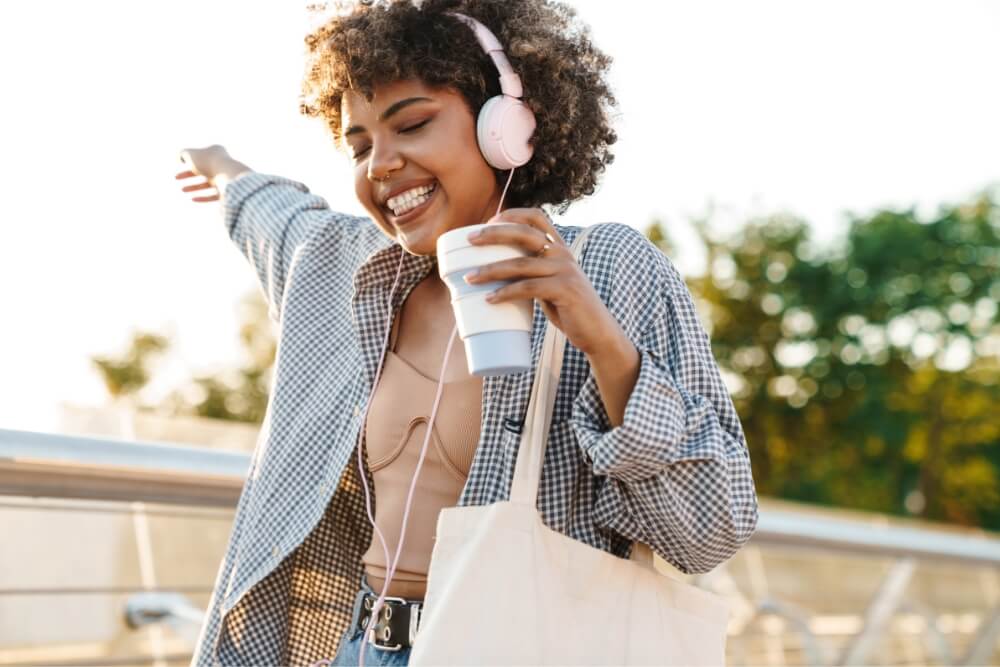 Tech-Travel-Essentials-2 African women enjoying music with headphone on road