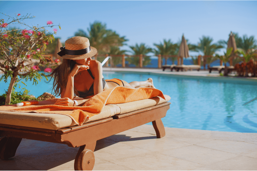 Woman in swimwear relaxing by the pool