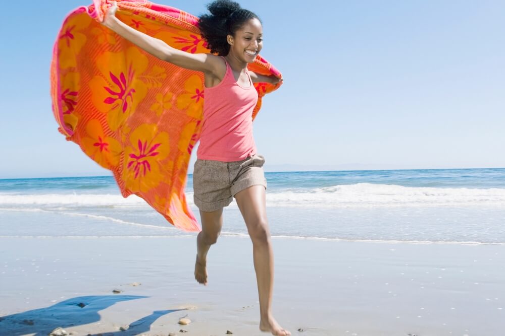 Beach Vacation African women running in towel on beach