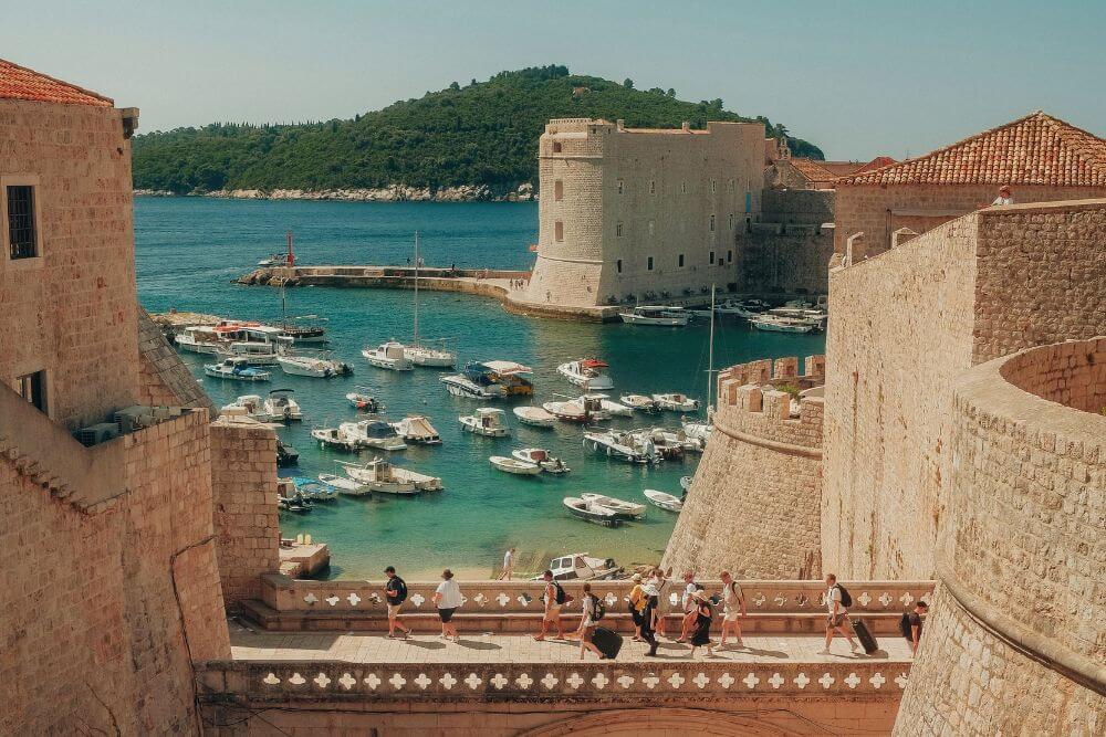 Untitled design (49) scenic view of dubrovnik's historic harbor